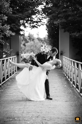 At Domaine de Blanche Fleur in Provence, a cinematic black-and-white portrait captures the couple in a dip kiss on the footbridge.